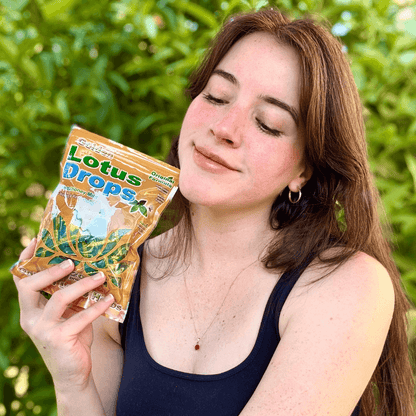 Woman holding a bag of Golden Lotus Original Herbal Honey Mint Throat Lozenges, showcasing natural and soothing sore throat relief with Traditional Chinese Medicine-inspired ingredients.